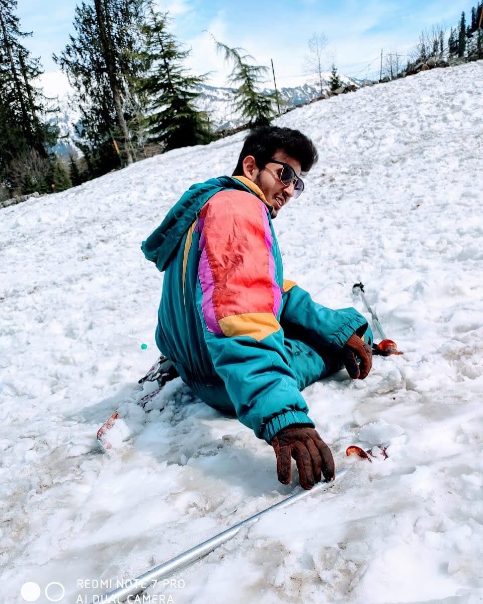 Moksh fell in the snow at a mountain.